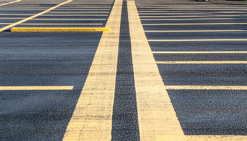 Professional pavement marking and line striping in a commercial parking lot. Professional pavement marking and line striping in a commercial parking lot.